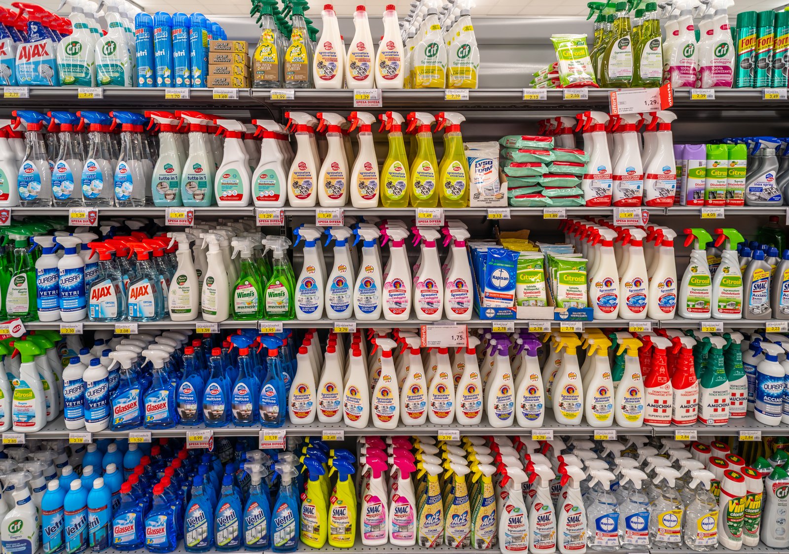 Common household cleaning products lined up on a shelf